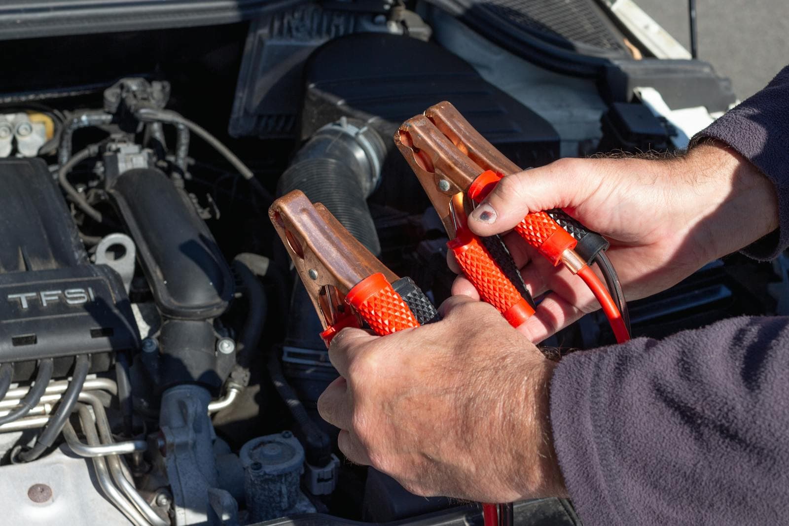 Technician testing a car battery and charging system