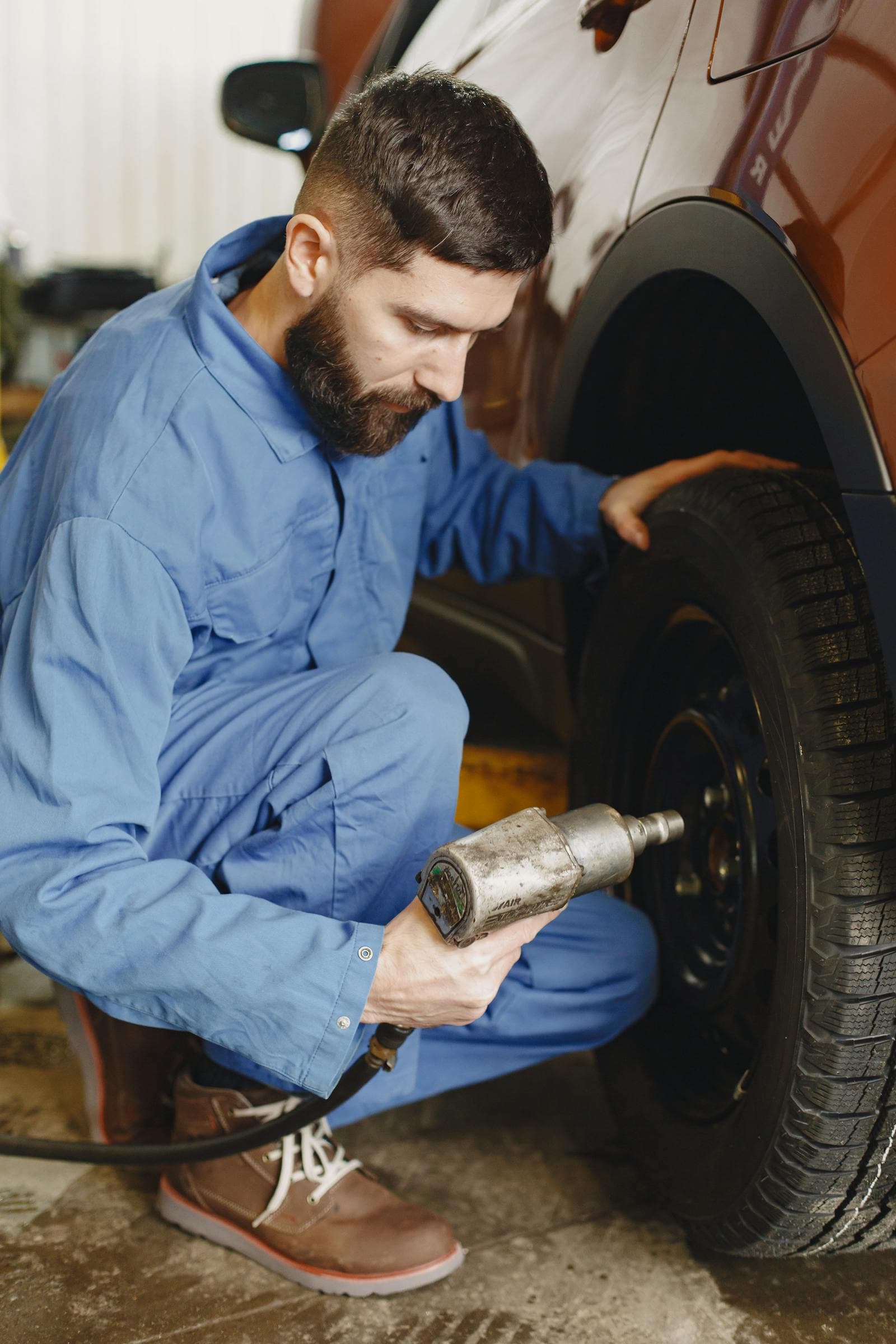 Technician working on a wheel and tyre in a workshop