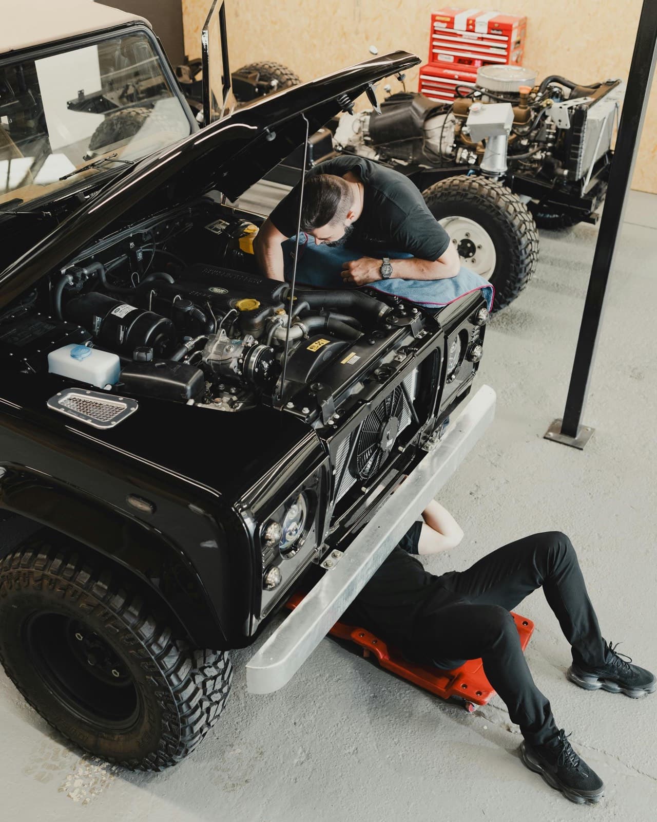Mechanic inspecting vehicle details inside a service workshop