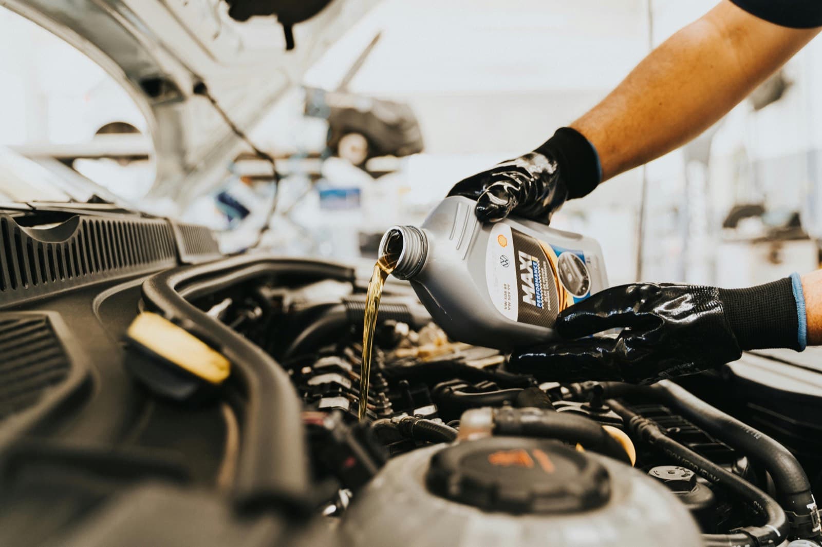 Engine oil being poured during a scheduled car service